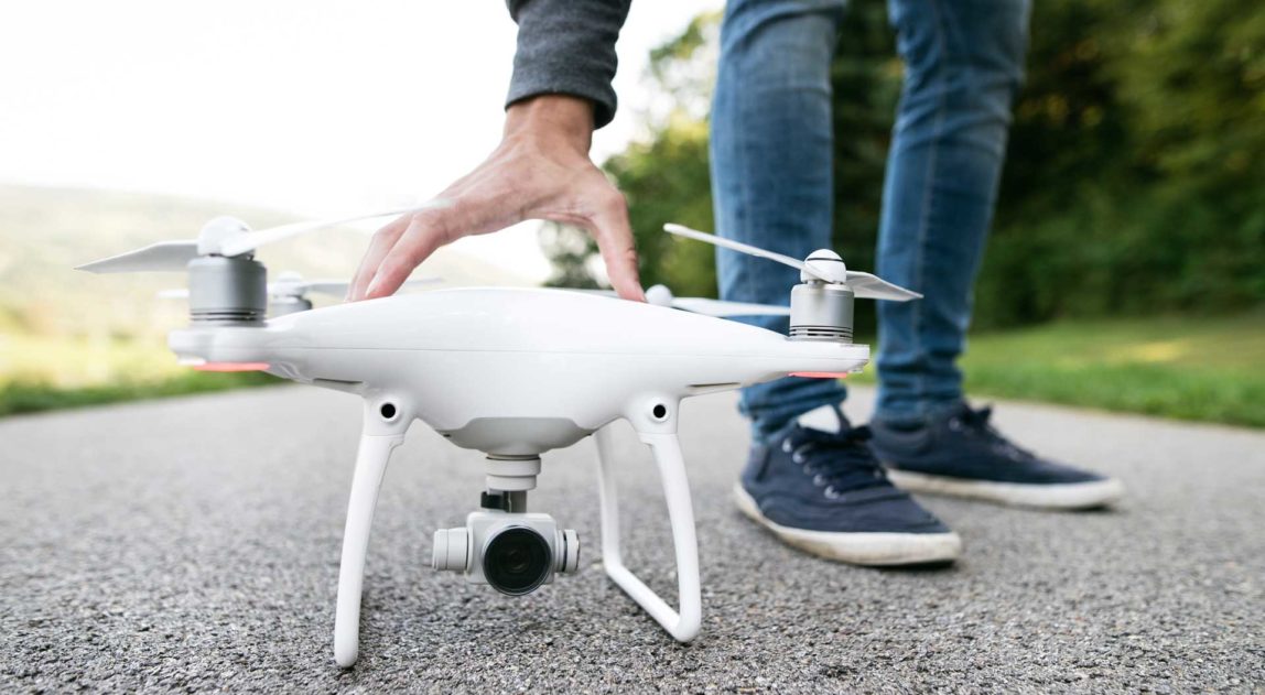 unrecognizable-man-with-drone-sunny-green-nature-c-PKFLLWC.jpg